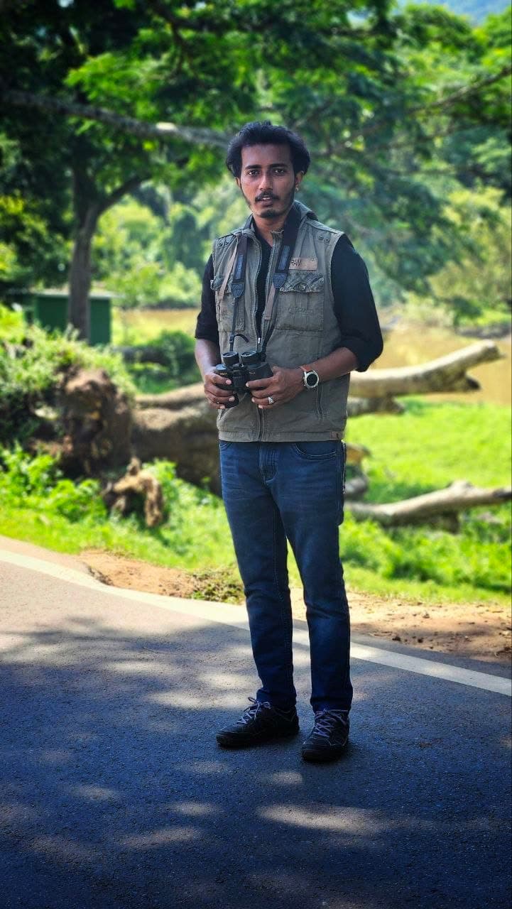 A field survey in the Western Ghats. Most of the research here begins with someone standing in a landscape with binoculars.
